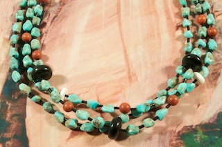 Beautiful 3 Strand Necklace featuring Genuine Kingman Turquoise, Jasper and Jet.  Jet Heishi and Penshell Heishi Accents. Sterling Silver Cones and Clasp. Created by Santo Domingo Artist Carol Pacheco.